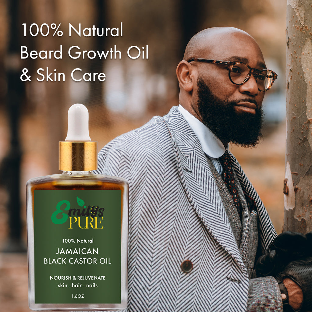 Man with a beard wearing glasses and a suit, with a bottle of Emily's Pure Jamaican Black Castor Oil 1.6oz in front.