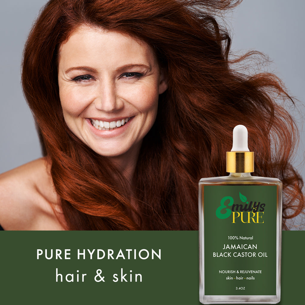 Woman with flowing red hair next to a bottle of 'Emily's Pure' Jamaican Black Castor Oil 3.4oz Pure Hydration hair skin